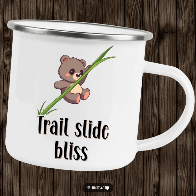 Funny bear cub camping mug showing a clumsy cub sliding down a giant blade of grass, for humorous outdoor trips.