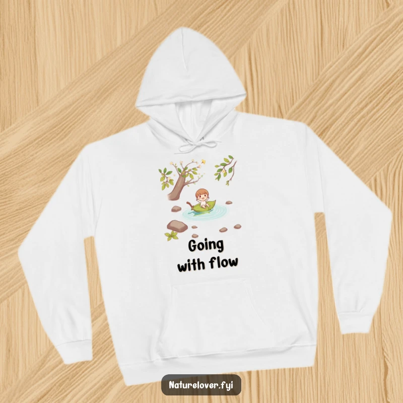 Funny small character joyfully floating down a stream on a fallen leaf boat, printed on a soft and warm hoodie.