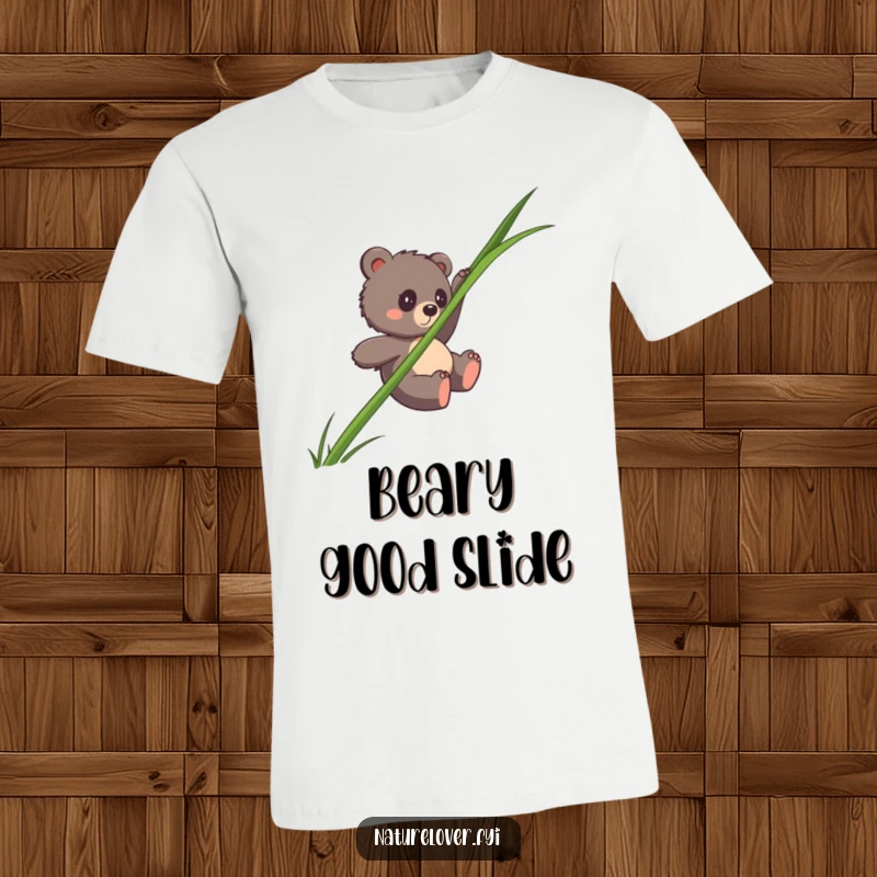 Funny bear cub t-shirt depicting a clumsy cub gracefully (or not) sliding down a huge blade of grass, great for humor fans.